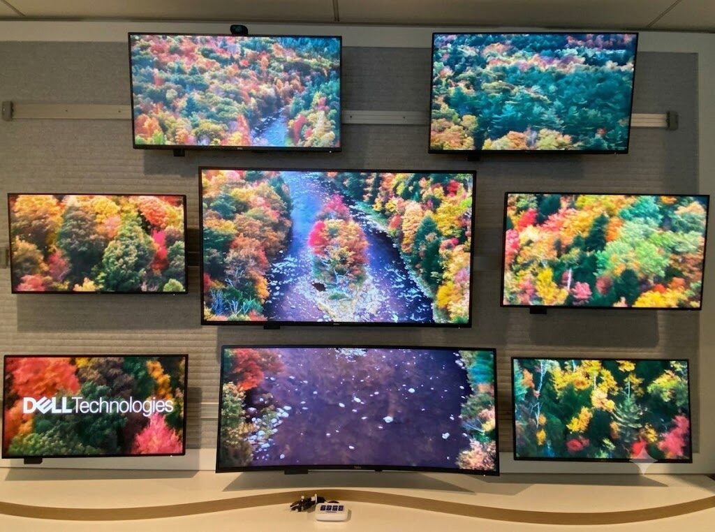 Fortune 50 tech customer solution center multi-screen video wall on a custom wood base