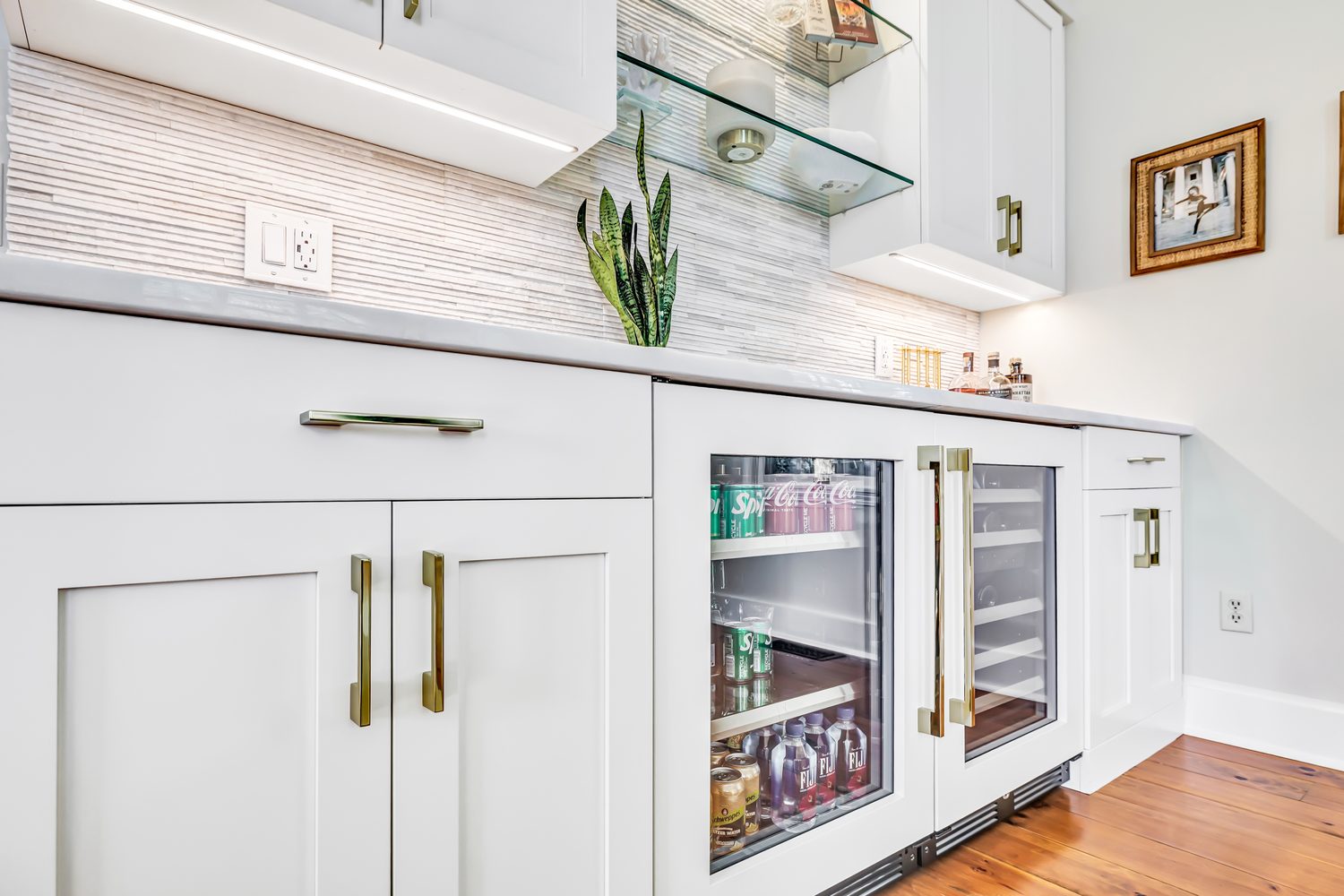 Custom built-in beverage bar with glass-front cabinetry and refrigeration