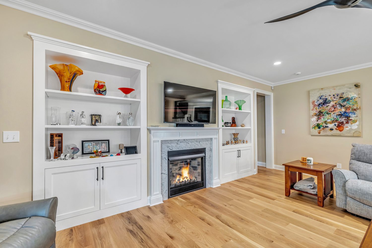 Custom home study built-ins with shelving flanking a fireplace