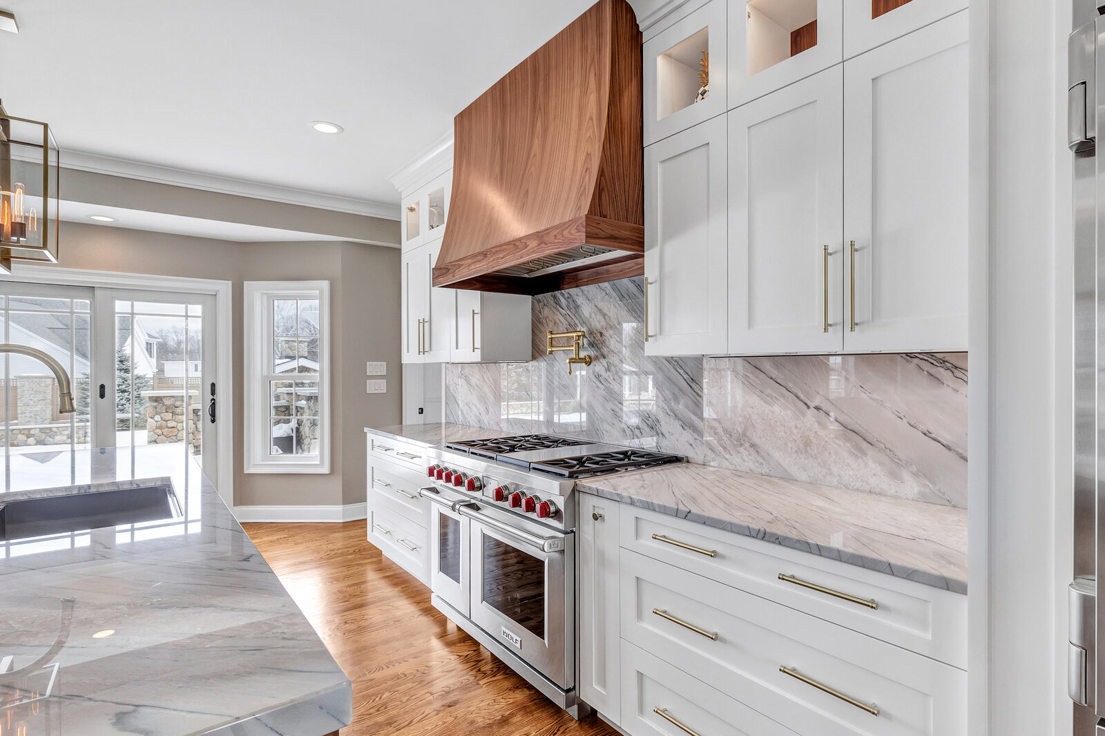 Walnut hood and range in a finished kitchen