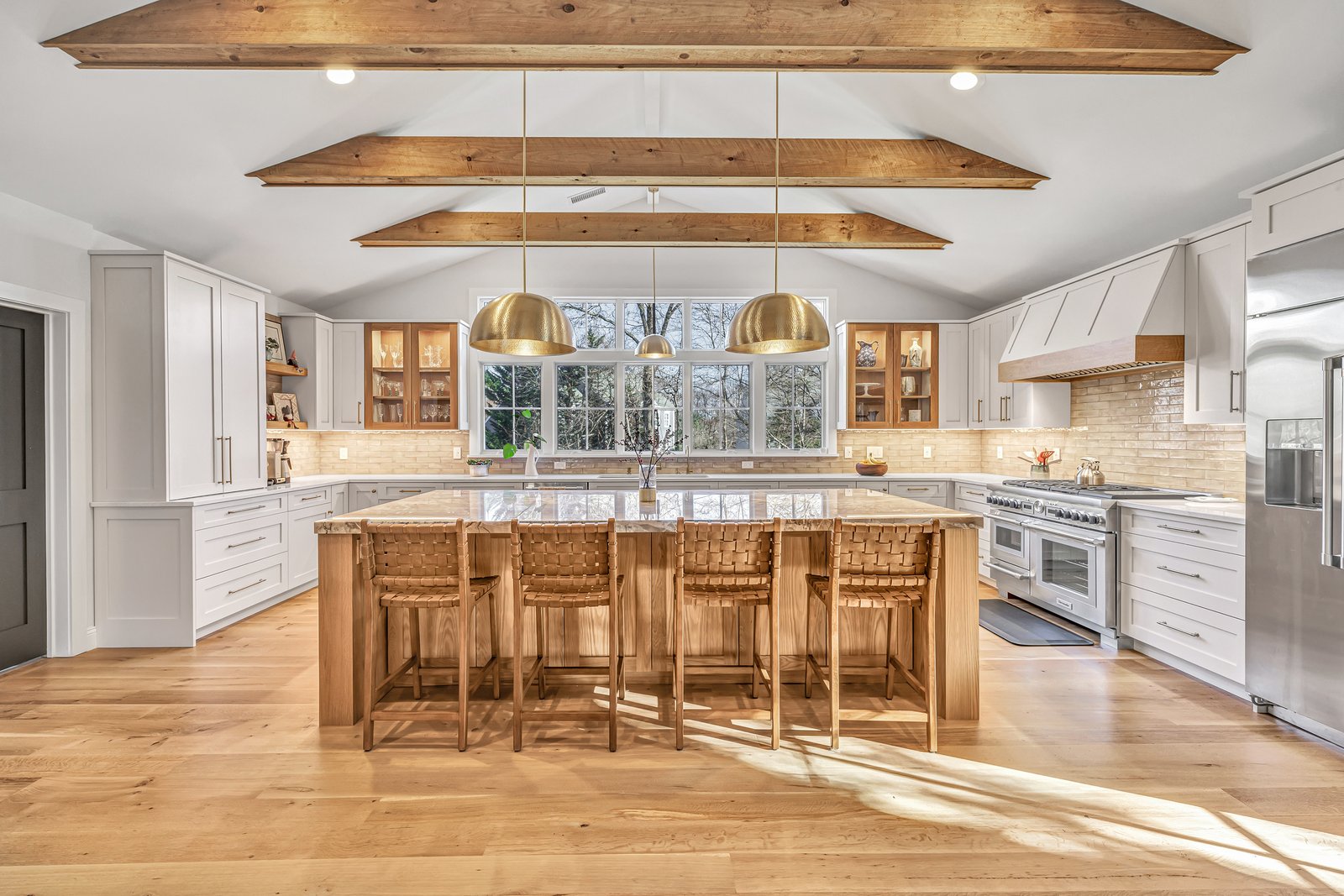 Residential kitchen with vaulted, beamed ceiling and a large center island